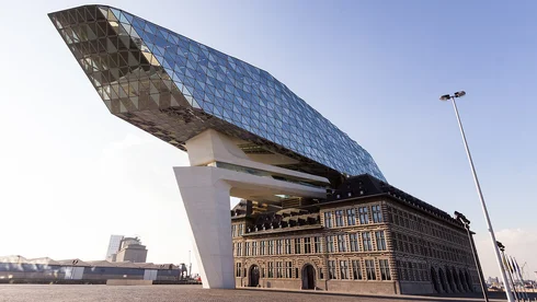 Old building with modern construction with glass façade above