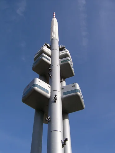 Television tower from below with figures apparently climbing the tower