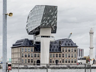 Old building with modern construction with glass façade above