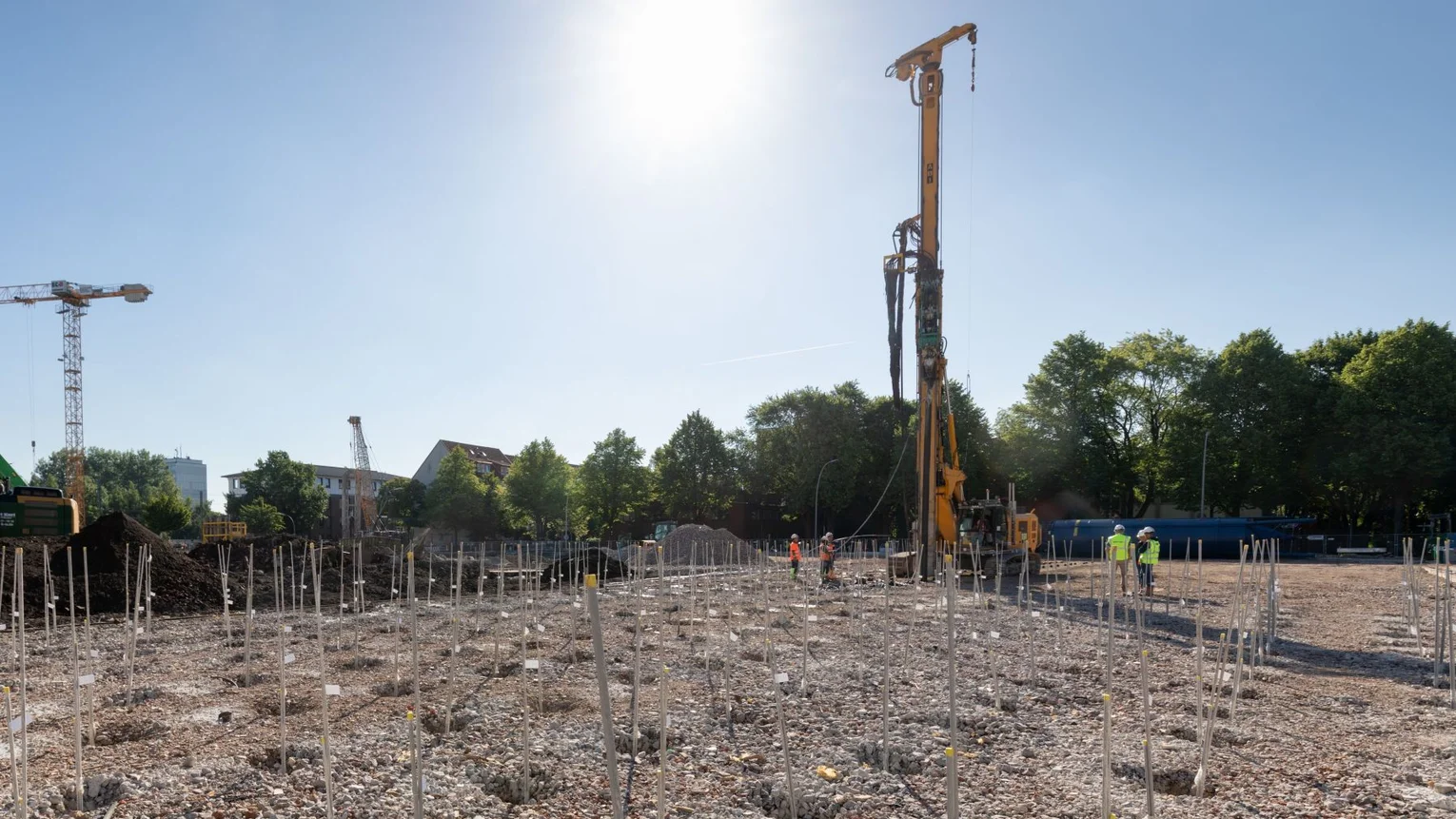 Construction site with construction workers and large drill